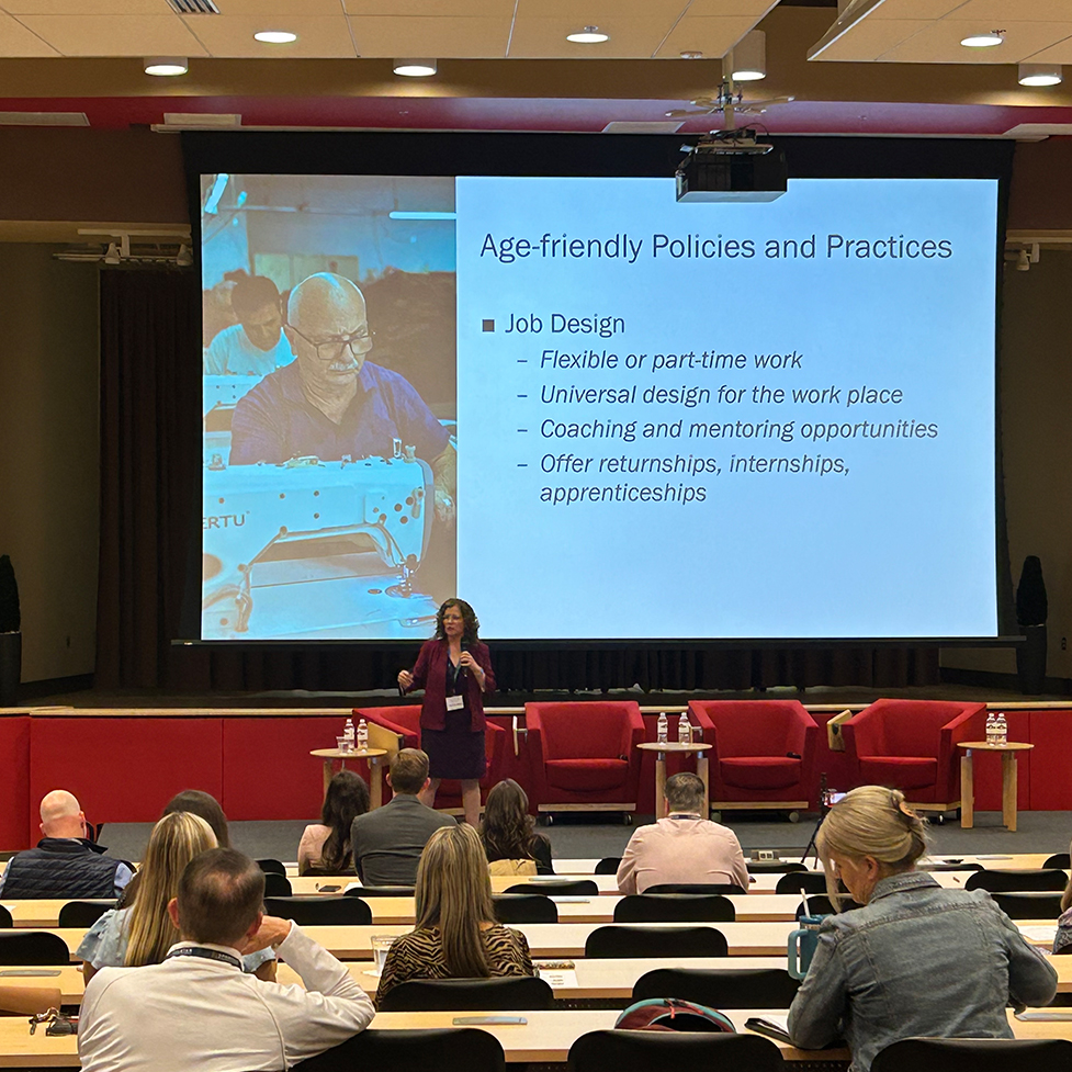 Dr. Corinne Auman speaking to an audience